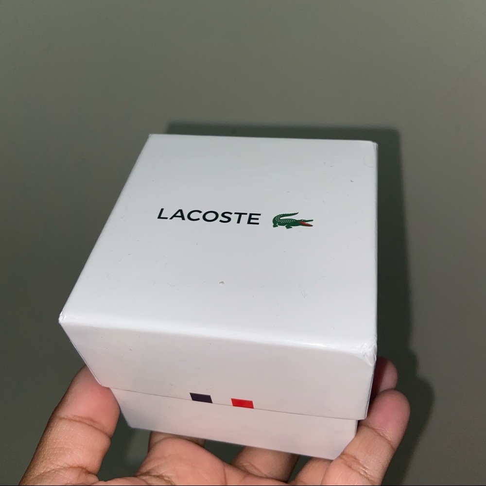 Lacoste watch totally new and with label, in box and its protector